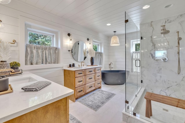 bathroom with wood ceiling, a healthy amount of sunlight, and vanity