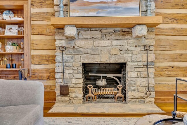 details featuring a stone fireplace and hardwood / wood-style floors