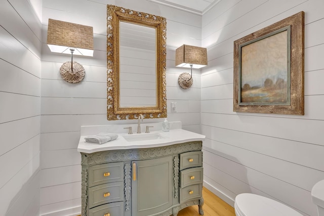 bathroom featuring vanity, hardwood / wood-style floors, and toilet