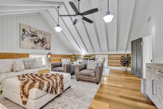 bedroom with beam ceiling, ceiling fan, and hardwood / wood-style floors