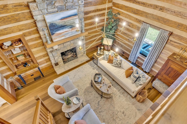 living room featuring a fireplace, lofted ceiling with beams, and hardwood / wood-style floors