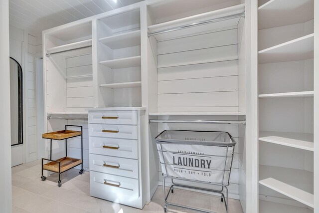 spacious closet with light tile floors