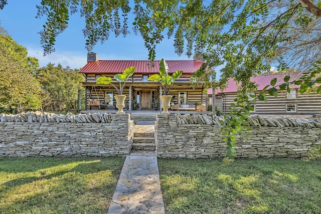 cabin with a front lawn