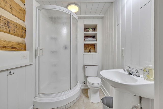 bathroom with sink, built in features, a shower with door, tile patterned flooring, and toilet