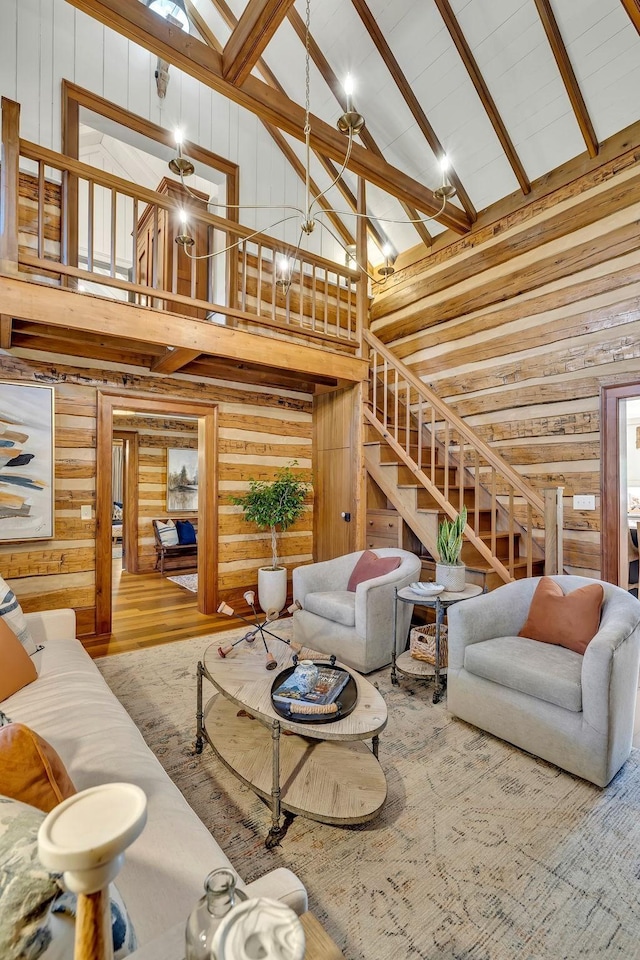 living room with high vaulted ceiling, hardwood / wood-style flooring, and a skylight