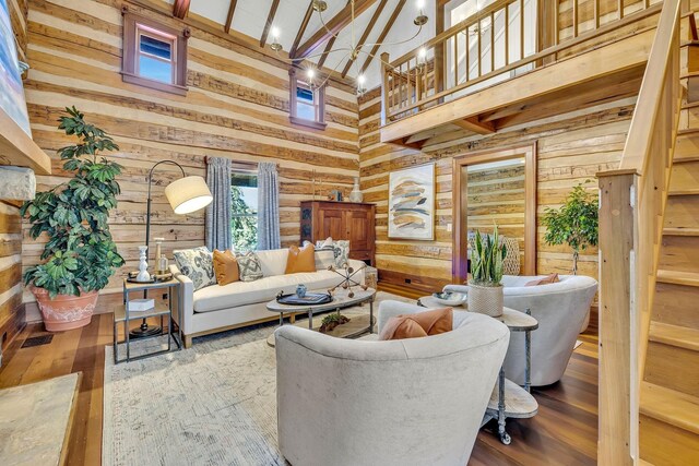 living room with wooden walls, high vaulted ceiling, beam ceiling, and wood-type flooring