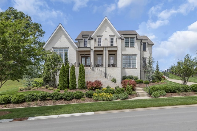 view of front of property featuring a balcony and a porch