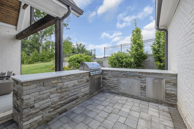 view of patio with area for grilling and exterior kitchen