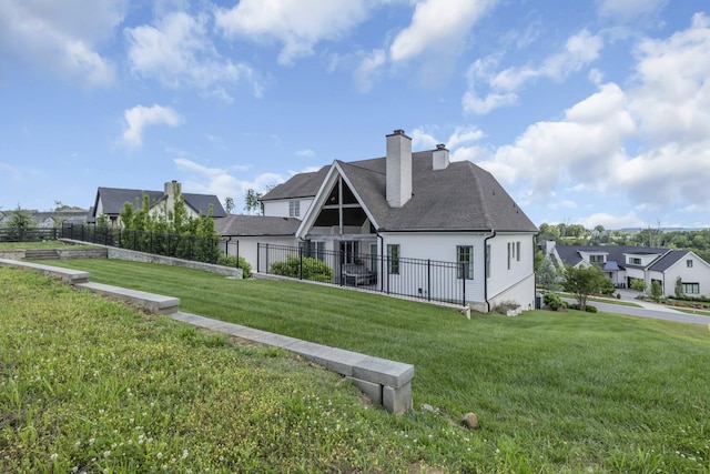 back of house featuring a lawn