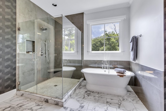 bathroom with separate shower and tub, tile walls, and crown molding