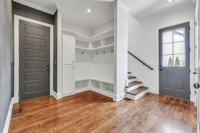 mudroom with wood-type flooring and crown molding