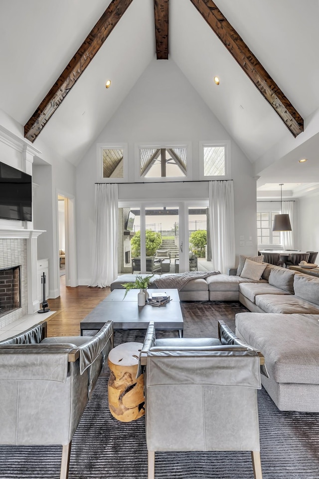 living room with hardwood / wood-style floors, beamed ceiling, and high vaulted ceiling