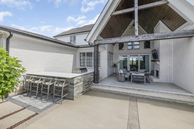 view of patio / terrace with outdoor lounge area, an outdoor kitchen, and an outdoor bar