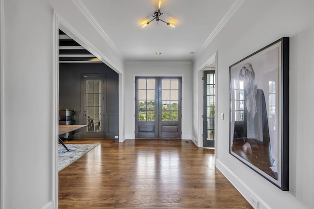 entrance foyer with french doors, dark hardwood / wood-style floors, and crown molding