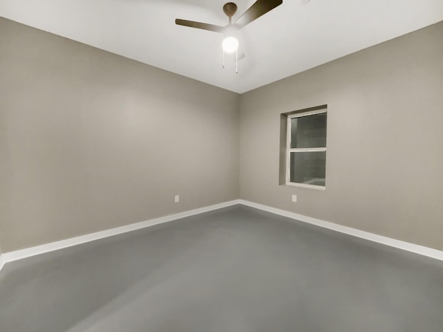 unfurnished room featuring ceiling fan and concrete flooring