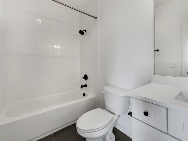 full bathroom featuring toilet, vanity, tile patterned floors, and tiled shower / bath combo