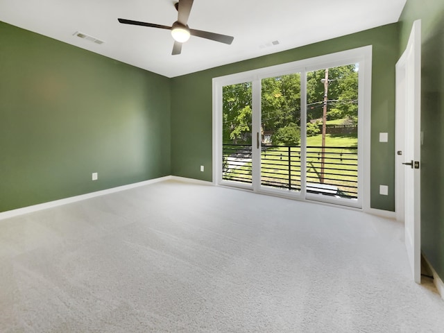 empty room with light colored carpet and ceiling fan