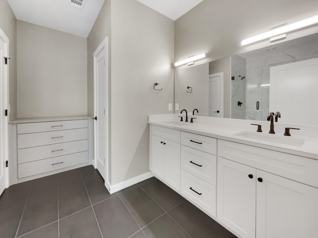 bathroom featuring tile patterned floors, vanity, and walk in shower