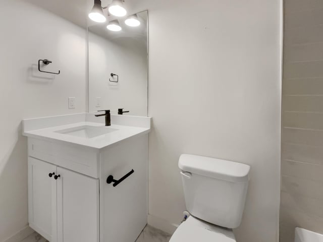 bathroom featuring vanity and toilet