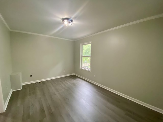 spare room with dark hardwood / wood-style floors and ornamental molding