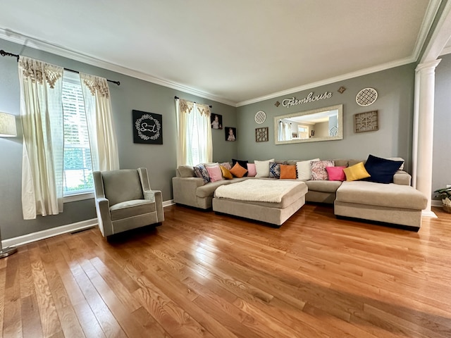 living room with ornamental molding, decorative columns, and hardwood / wood-style floors