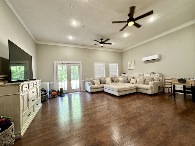 living room featuring ceiling fan, french doors, a wall unit AC, dark hardwood / wood-style flooring, and a textured ceiling