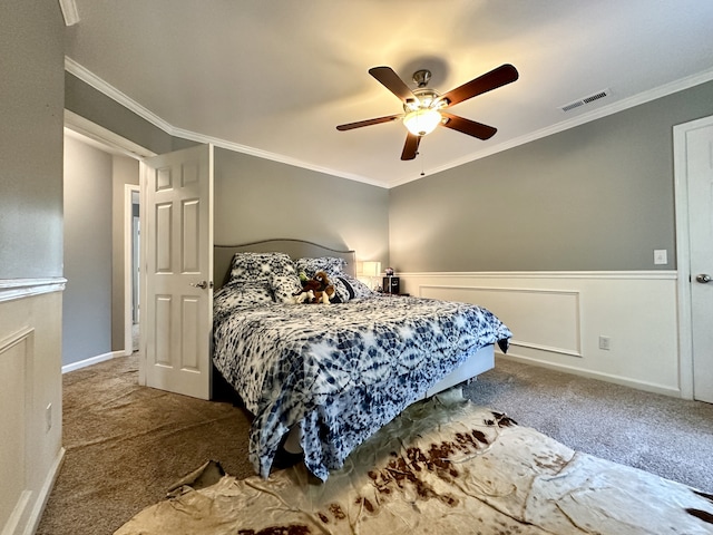 carpeted bedroom featuring ceiling fan and crown molding