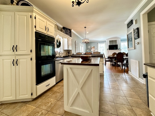 kitchen with black double oven, dishwasher, a center island, ornamental molding, and pendant lighting