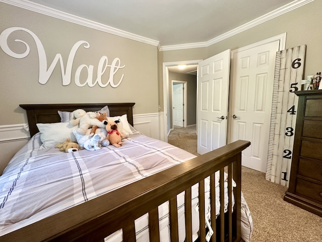 carpeted bedroom with a closet and crown molding