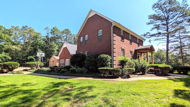 view of side of home featuring a pergola and a lawn