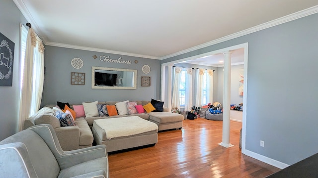 living room with ornamental molding, hardwood / wood-style flooring, and ornate columns