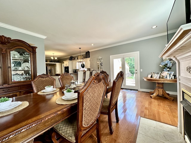 tiled dining room with french doors and crown molding