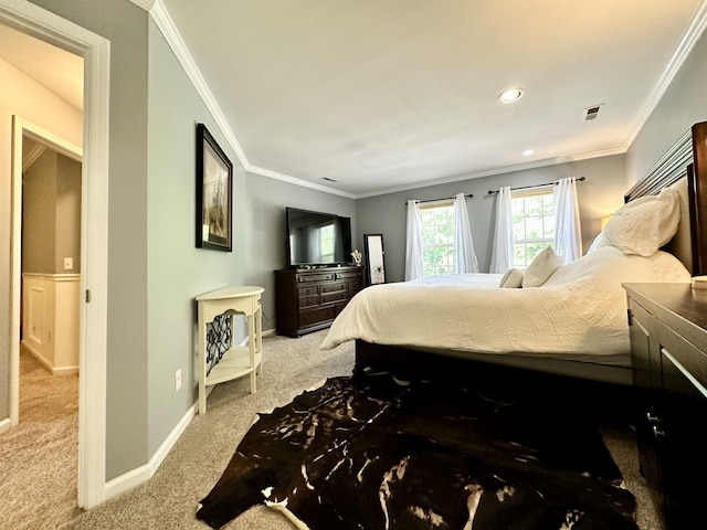 bedroom featuring crown molding and carpet