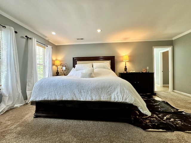 bedroom with ornamental molding and carpet floors