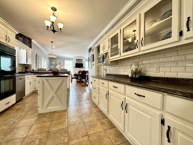 kitchen featuring hanging light fixtures, ornamental molding, stainless steel appliances, backsplash, and light tile floors