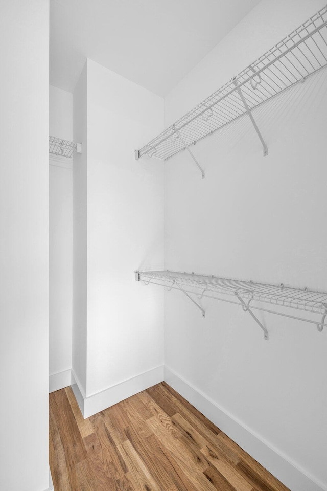 walk in closet featuring hardwood / wood-style floors