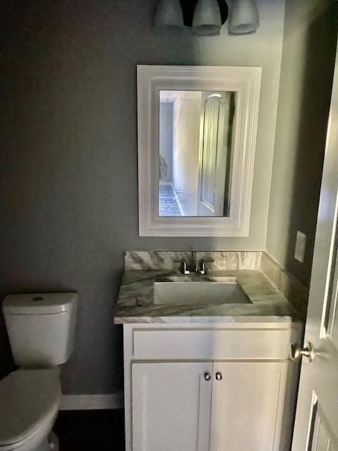bathroom featuring toilet and vanity