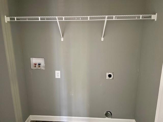 clothes washing area with electric dryer hookup, baseboards, washer hookup, and laundry area