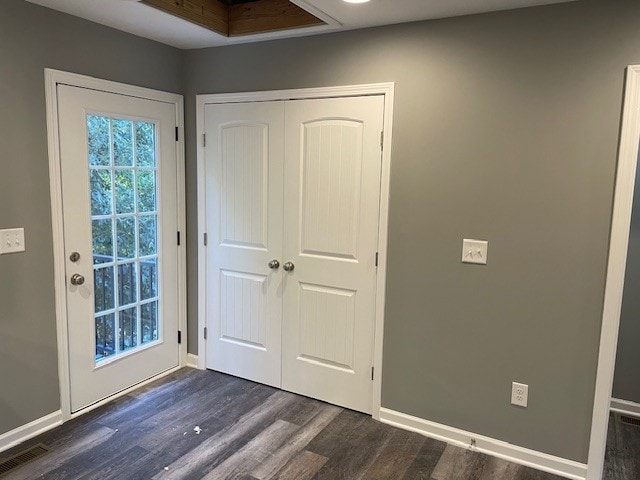 doorway with dark hardwood / wood-style flooring