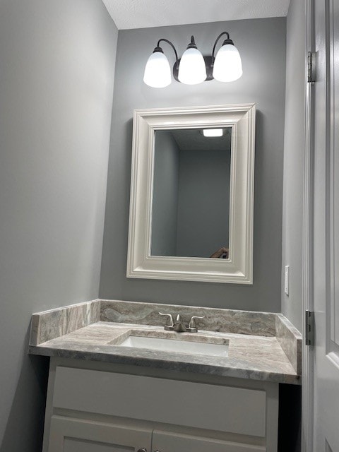 bathroom with a textured ceiling and vanity