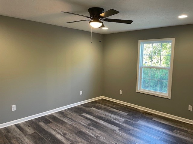 empty room featuring ceiling fan and dark wood-type flooring