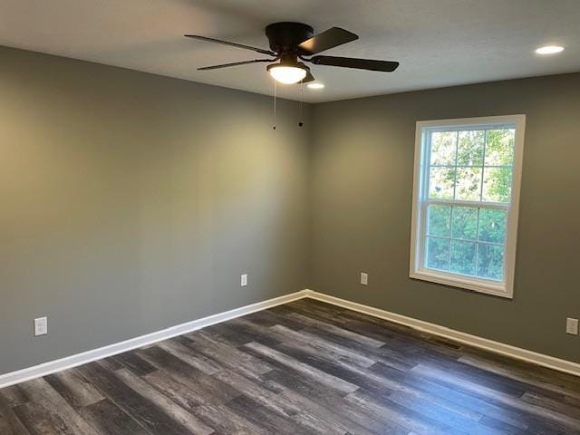 empty room featuring a ceiling fan, recessed lighting, dark wood-style floors, and baseboards