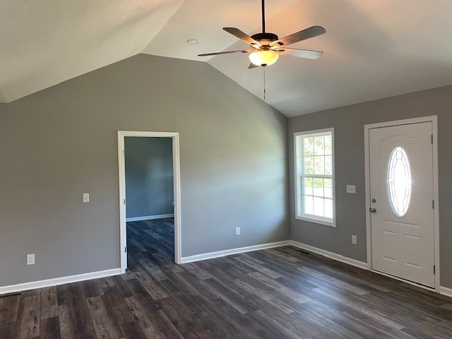 entryway with ceiling fan, dark wood-type flooring, and lofted ceiling