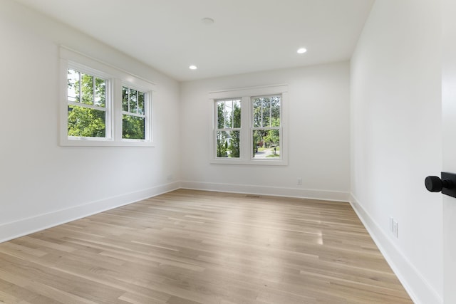 unfurnished room with light hardwood / wood-style floors