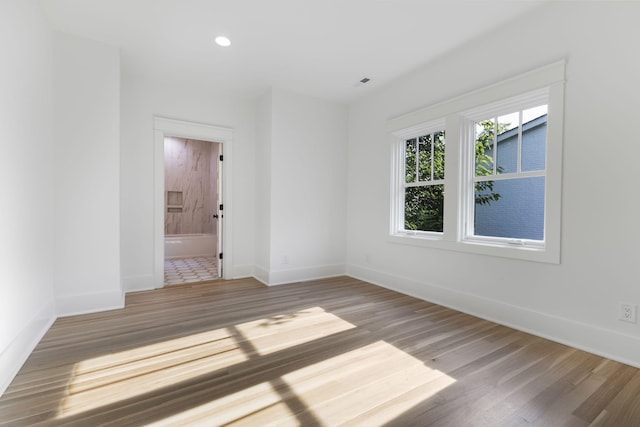 empty room with hardwood / wood-style flooring