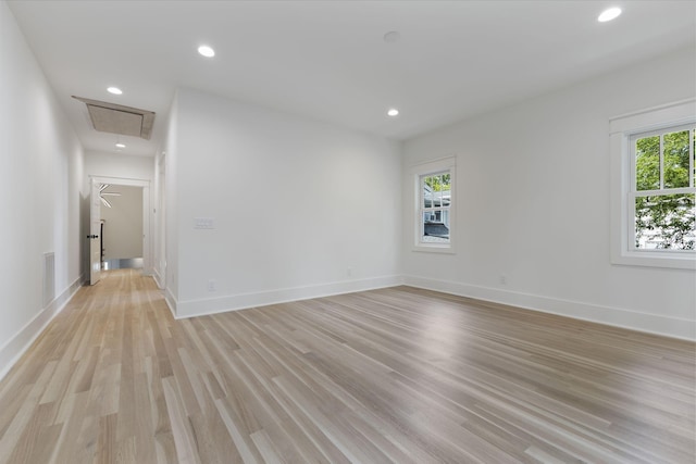 spare room featuring a healthy amount of sunlight and light wood-type flooring