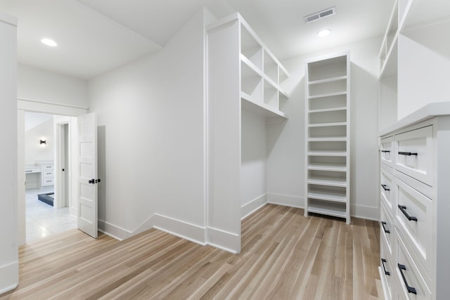 spacious closet with light hardwood / wood-style flooring