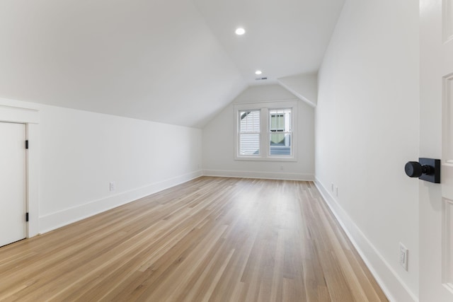 bonus room featuring lofted ceiling and light wood-type flooring