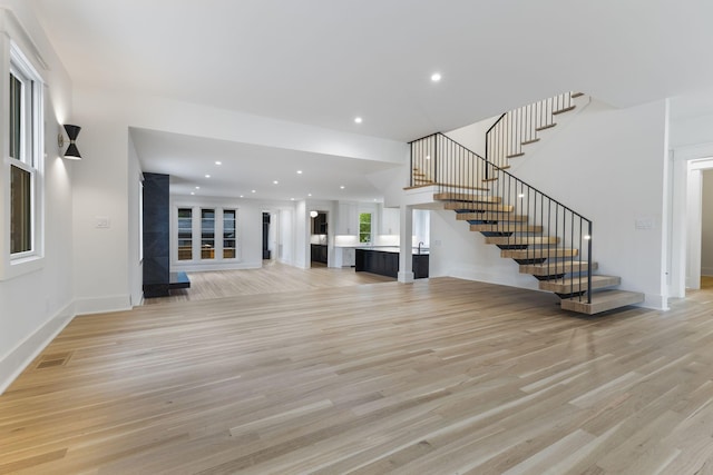 unfurnished living room featuring light wood-type flooring