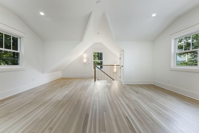 bonus room featuring vaulted ceiling and light wood-type flooring